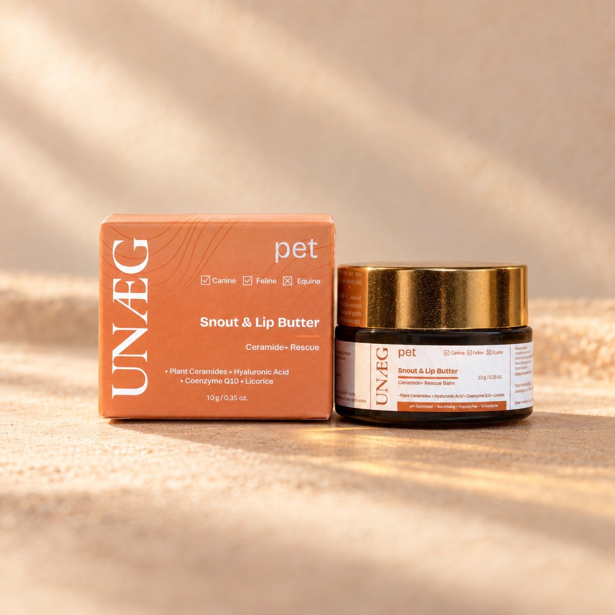 Snout & Lip Butter | Ceramide+ Rescue jar and box on a warm sand-toned background